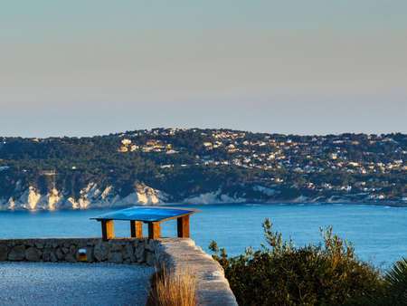Mediterranean seascape on Costa Blanca. Cape San Antonio with view of Javea coastal town, Alicante province, Spain.の写真素材