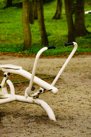 Outdoor gym in park during summer spring with nobody. Sport machines outside.