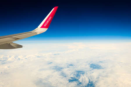 BERGEN, NORWAY - JULY 27, 2014: Wizzair airline wing. Sky view from the airplane window. W!zz Air is...