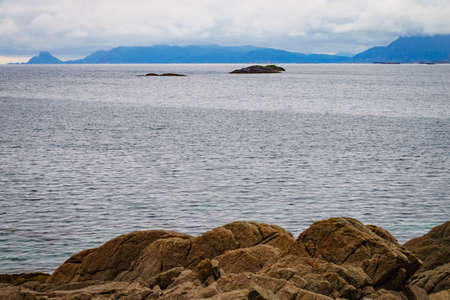 Sea landscape with stone isles on fjord Vjestfjord, Lofoten islands, Henningsvaer region, Norway....