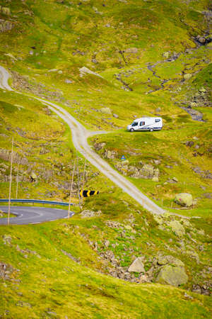 Camper car in green summer norwegian mountains. Travel in motor home, holidays and adventure concept.の写真素材