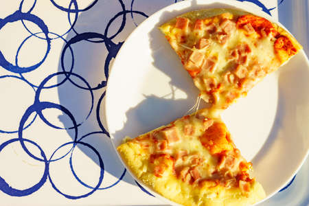 Pizza slices on plate, outside meal. Top down view