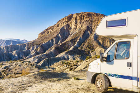 Caravan vehicle camping on nature in mountains. Tabernas desert, Almeria province, Andalusia Spain. Traveling in mobile home.の写真素材