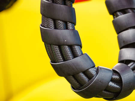 Hydraulic connections hoses in black spiral guard wraps. Machinery industrial detail