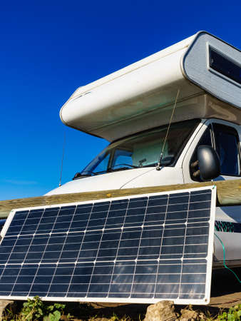 Portable solar photovoltaic panel, charging battery at camper car rv.の写真素材