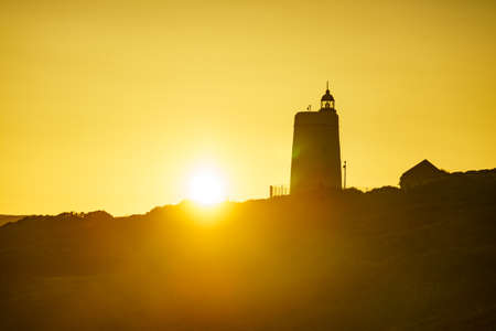 Sunset over Carbonera Lighthouse located on Punta Mala, La Alcaidesa, Spain. Lantern overlooks the Strait of Gibraltar.の写真素材
