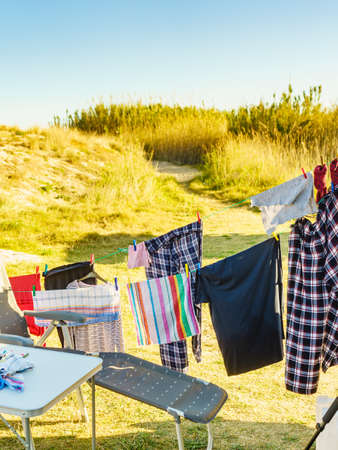 Camping on beach, adventure concept. Clothes hanging to dry on laundry line outdoor.の写真素材