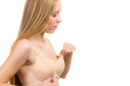 Slim young woman small boobs wearing too big bra. Female breast wrong size lingerie. Bosom, brafitting and underwear concept.の写真素材