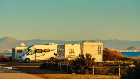 Camping on sea beach. Spanish Costa Blanca coastline with camper cars, Spain Alicante province.