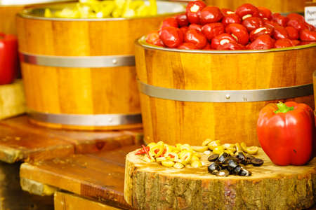 Olives and peppers for sale at outdoors food market.の写真素材