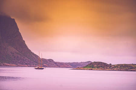 Sailing ship on water sea, norwegian fjord nature. Cruising, travel by sailboat, vacation trip for pleasure. Lofoten Norwayの写真素材