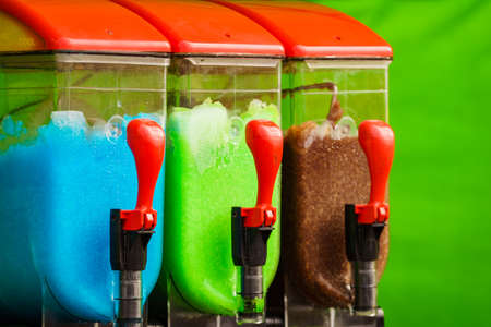 Slush machine. Slushy ice made colorful drink refreshing during summer. Granita distributor. Different flavors.の写真素材