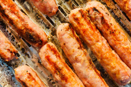 Close up delicious sausages or bratwurst on barbecue gas grill. Barbeque meat dinner outdoor.の写真素材