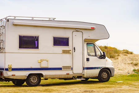 Camper car camping on sea beach. Traveling in motorhome.の写真素材
