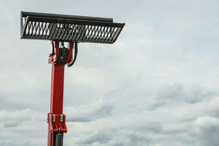 Industrial hay telehandler against sky. Telescopic handler. Agricultural machinery, farm equipment....