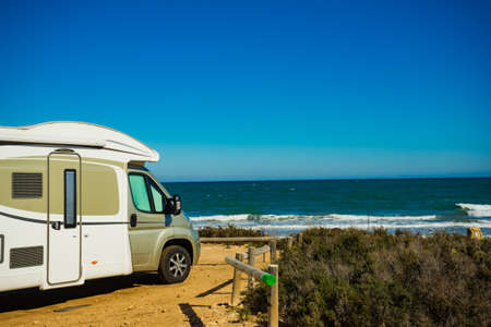 Camper, recreational vehicle on mediterranean coast in Spain. Camping on nature beach. Holidays and...