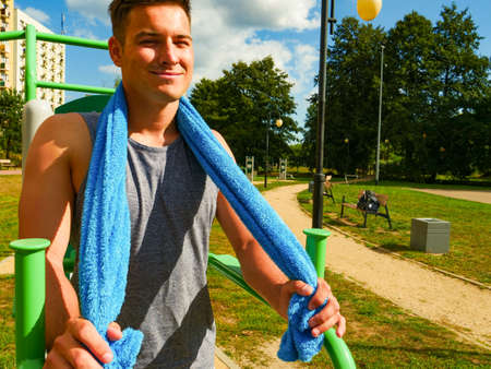 Handsome guy relaxing after outdoor workout. Fit man feeling healthy enjoying sun