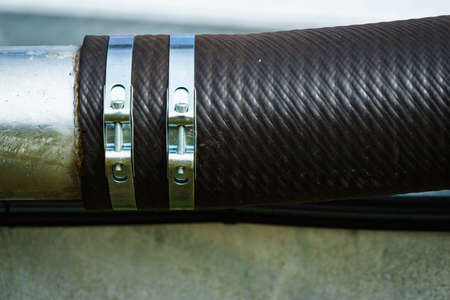 Metal clamps in use, connection hose, detail view
