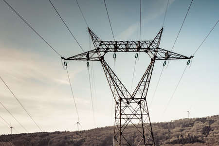 Electricity transmission pylon, power line voltage tower post against sky