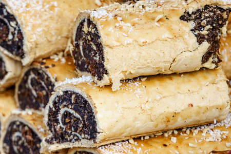 Fresh strudel poppy seed rolls. Delicious cakes at food market.