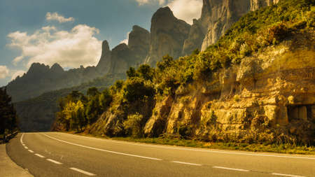 Asphalt road winding through the mountains of Montserrat, rocky landscape, Catalonia Spain.の写真素材