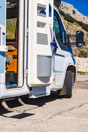Camper, recreational vehicle outdoor and trash can on door entrance. Camping on nature. Holidays and travel in caravan.の写真素材