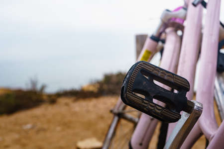 Bicycle outdoor parked on beach sea shore. Pedal element. Holidays, sport and summer recreation.