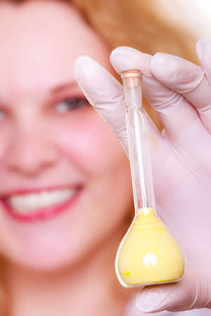 Chemist woman, girl student, female laboratory assistant or scientific researcher with chemical glassware test flask. Experiment, research in progress.の写真素材