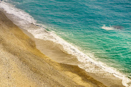 Sandy beach sea shore with splashing waves