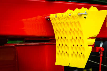 Yellow chock at big industry machine. Wedge or block used to prevent a wheel from rolling. Device...