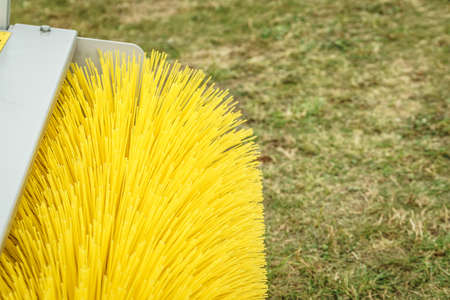 Detail of agricultural vehicle rotary boom brush sweeper.