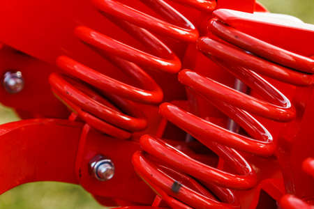 Hard made of steel spring at heavy machine. Machinery industrial detail