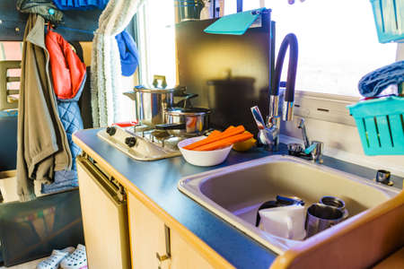 Caravan rv inside, kitchen area. Cooking in campervan. Holidays, adventure with motor home. Van life...