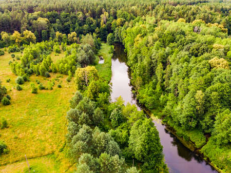 Aerial view. Green forest and river Brda, canoe trail in Tuchola national park, Poland. Green summer landscape in Europe.の写真素材