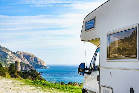 Motor home on spanish coast, seaside cliffs of Maro Cerro Gordo. Costa del Sol, Andalusia Spain. Visiting warm winter travel destinations.の写真素材