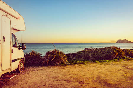 Caravan rv on mediterranean coast in Spain. Gibraltar rock on horizon. Camping on nature. Vacation...