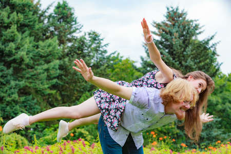 Happy couple having fun together outdoor. Happiness, great relationship. Man and woman fooling...