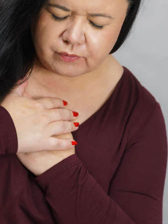 Adult woman having problem with health, having heart pain in chest. Mature female with cardiology...