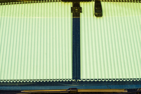 Camper with internal thermal screen blind at window pane. Detail view. Holidays and travel in motor...