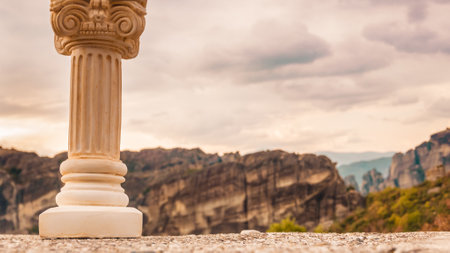 Greek column and view of huge rocks cliffs in Meteora, Greece. Holidays travel visiting new places for sightseeing.の写真素材