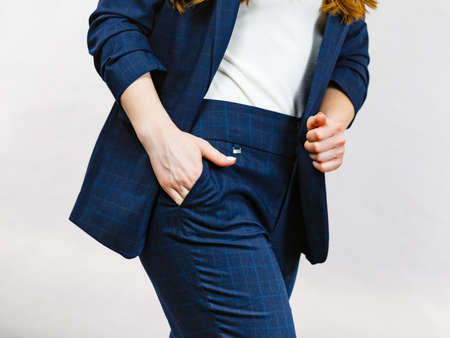 Business woman wearing suit holding hand in pants pocketの写真素材