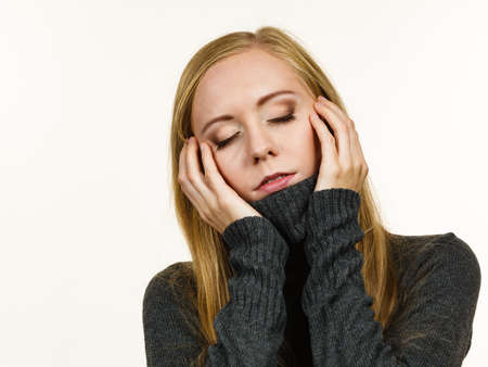 Sad young woman long hair teen girl wearing warm sweater lost in thought. Autumn sadness. Warm...