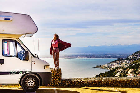 Mature tourist woman enjoy caravan vacation. Punta Falconera location with view of Gulf of Roses,...