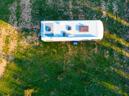 Aerial view. Caravan camping on green field. Holidays, traveling with motorhome.の写真素材