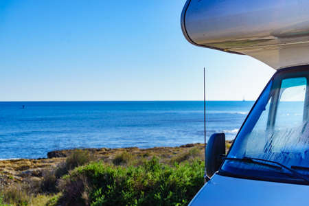 Camper rv caravan on mediterranean coast in Spain. Wild camping on nature beach. Holidays and traveling in motor home.の写真素材