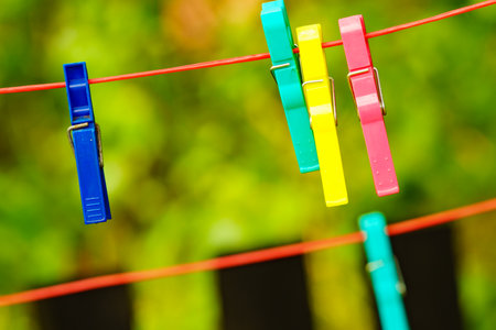 Clips for washing laundry clothes pegs on string rope outdoor. Housework conceptの写真素材