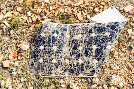 Broken destroyed cracked solar photovoltaic panel, charging batteries.
