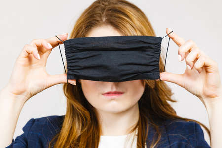 Business woman using protective face black mask againstの写真素材