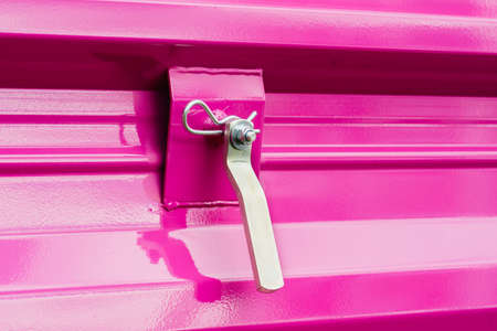 Construction machines concept. Detailed closeup of screw and bolts on pink indrustrial machineryの写真素材