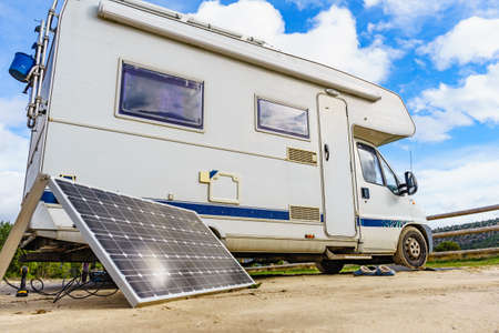 Portable solar photovoltaic panel, charging battery at camper vehicle.の写真素材